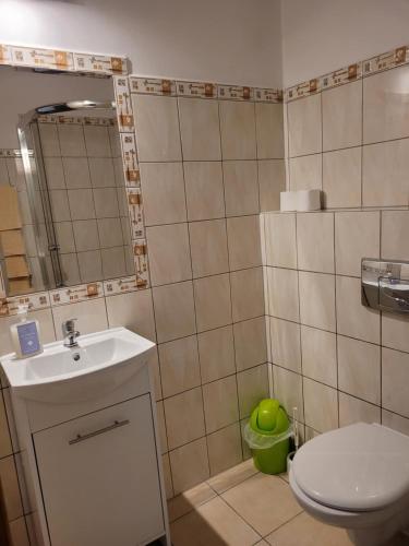 a small bathroom with a toilet and a sink at Willa Republika in Świętno