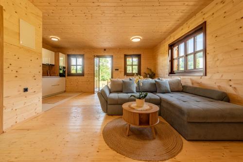 a living room with a couch and a table at Forest Paradise in Ličko Petrovo Selo