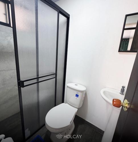 a bathroom with a toilet and a sink at Hospedaje Holcay in Bogotá