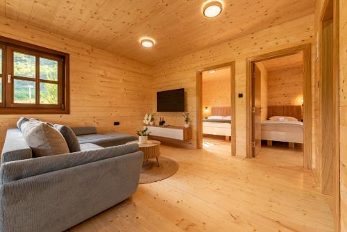 a living room with a couch and a bedroom at Forest Paradise in Ličko Petrovo Selo