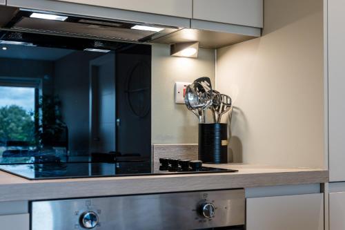 a kitchen with a counter with a sink and a stove at Richmond Apartments - Air Host & Stay in Liverpool