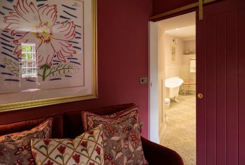 a living room with a couch and a painting on the wall at George and Dragon Clifton in Penrith