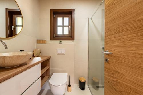 a bathroom with a sink and a toilet and a mirror at Forest Paradise in Ličko Petrovo Selo