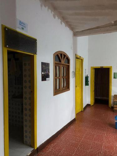 a hallway with two doors and a yellow door at ADVENTURE Hostel in San Gil