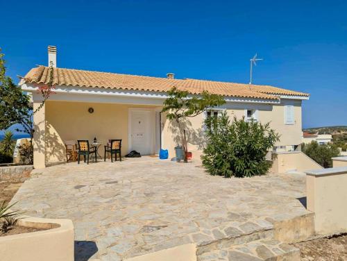 a house with a stone patio in front of it at The Lookout by Goutos Luxury Living in Rozaíika