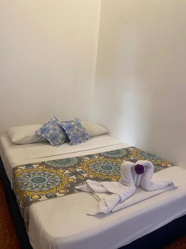 two towels on two beds in a room at ADVENTURE Hostel in San Gil