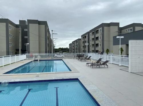 a large swimming pool on a building with buildings at AP a 3KM das PRAIAS, com SUÍTE in São Luís