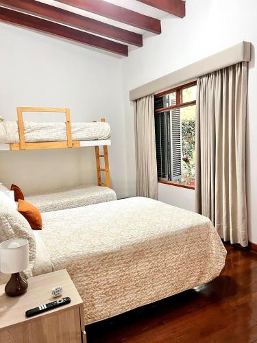 a bedroom with two bunk beds and a window at Casa Shanti in Cieneguilla