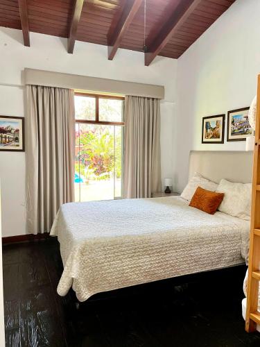 a bedroom with a large bed and a window at Casa Shanti in Cieneguilla