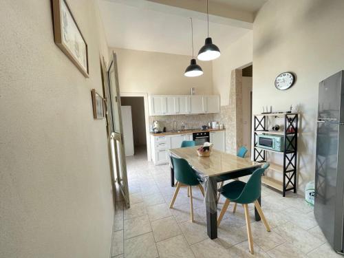 Una cocina con una mesa y sillas en una habitación. en Dolce Casa Salentina, en San Pietro in Bevagna