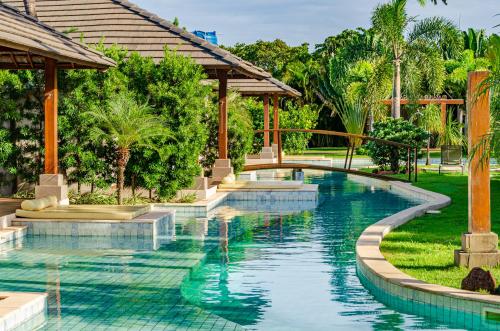 a swimming pool in a resort with a bridge at AWARA POUSADA BOUTIQUE in São Miguel do Gostoso