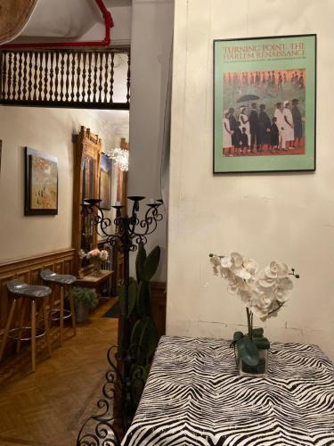 a room with a table and a poster on the wall at Harlem Brownstone in New York