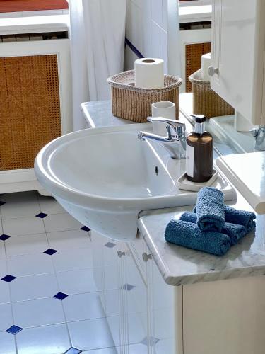 a white bathroom with a sink and a mirror at Villa Oasi Mariuccia - Relax e Mare in Lido di Jesolo