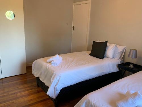 a bedroom with two beds with towels on them at Palm Haven on Sarnia in Durban