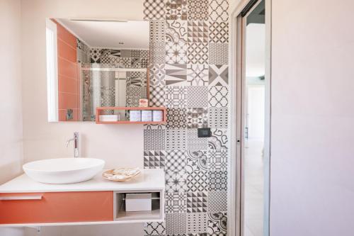 a bathroom with a sink and a shower at Mennuli e mari - sicily home in Brucoli