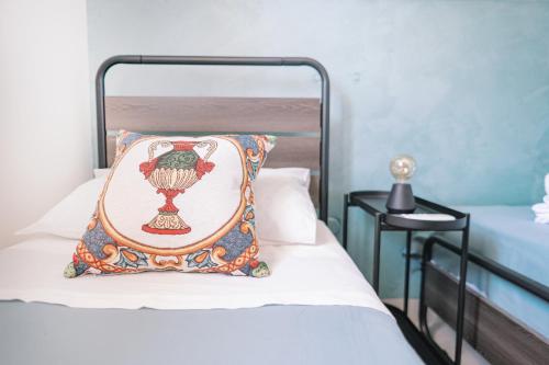 a bed with a pillow on top of it at Mennuli e mari - sicily home in Brucoli