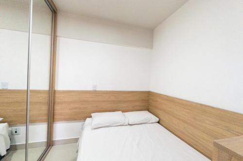 a bedroom with a bed and a glass wall at Veja Este Apê Completo! - PS505 in Maringá