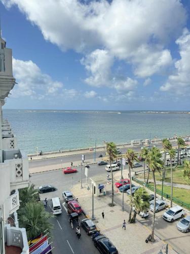 a view of a parking lot next to the ocean at Acropole Alexandria Hotel in Alexandria
