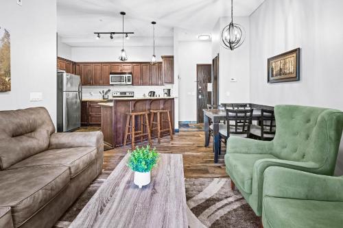 a living room with two couches and a kitchen at Mountain Getaway in Canmore - Sleeps 6 - Pool & Hottub in Canmore