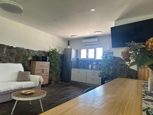 a living room with a couch and a table at Villa Rural Nuestro Rincón in Sanlúcar de Barrameda