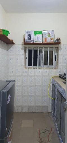 a kitchen being remodeled with a wall with windows at Appartement meublé à Fidjrossè Cotonou in Cotonou