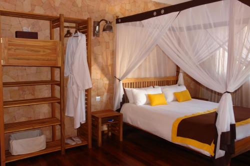 a bedroom with a bed and a bunk bed at Hotel Sakamanga in Antananarivo