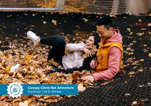 a man and a woman laying in leaves at The Westin Trillium House, Blue Mountain in Blue Mountains