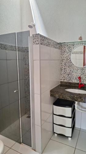 a bathroom with a shower and a sink at Casa Beija Flor - Baleia Beach in Itapipoca