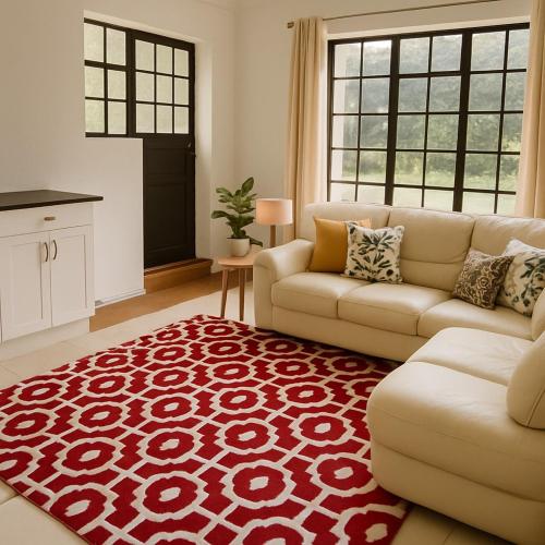 a living room with a couch and a red rug at Lewka House in Nairobi