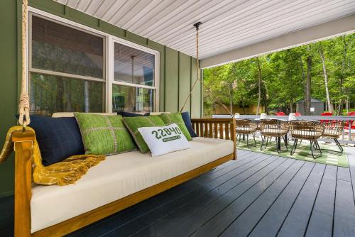 a couch sitting on a porch with a patio at Hawksbill Hideaway in McGaheysville