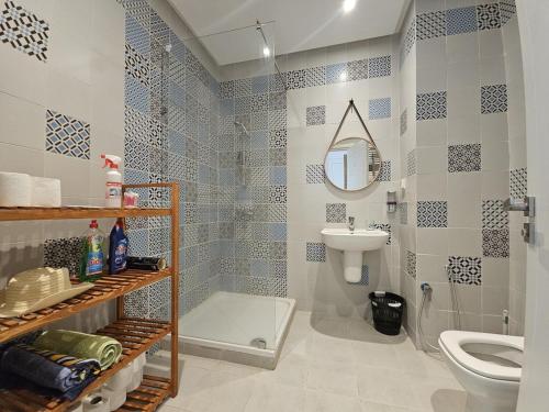 a bathroom with a toilet and a sink at Chic Apartment Near the Sea in Yasmine