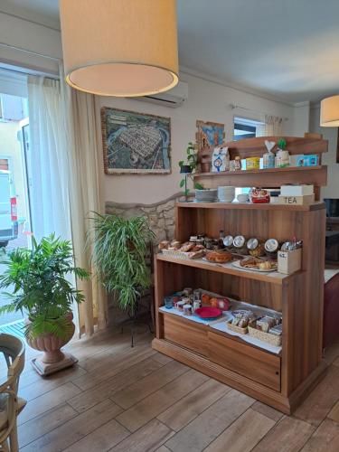 a display case in a room with some food at Florivana Boutique Hotel in San Pietro in Cariano