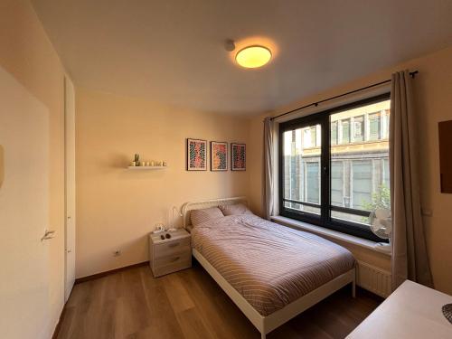 Postel nebo postele na pokoji v ubytování BXL cozy appartment