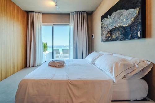 a bedroom with a large bed with a large window at Hybrid Icon Rooms Gallery in Palermo
