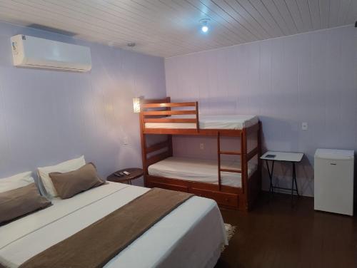Postel nebo postele na pokoji v ubytování Hotel Coração Verde