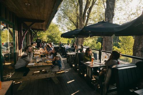 a group of people sitting at tables at a restaurant at MacTaverne in Val-David