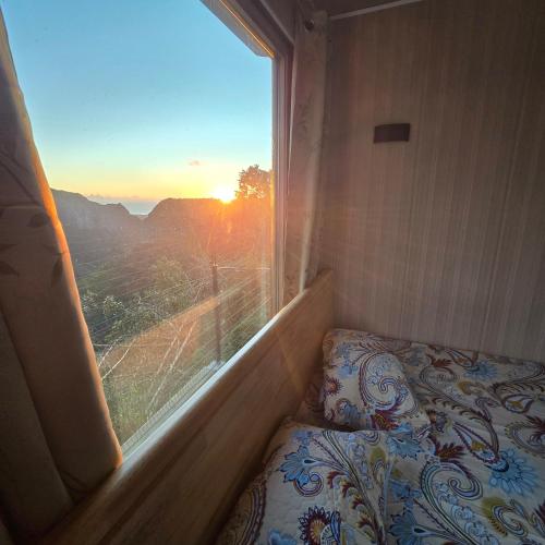 a room with a bed and a window with a view at Green Discovery's Birds' Nests in Henrietta