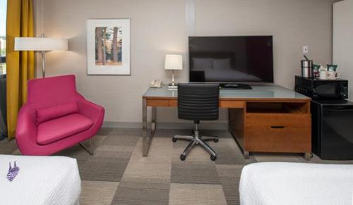 a room with a desk and a chair and a computer at Coast Prince George Hotel by APA in Prince George