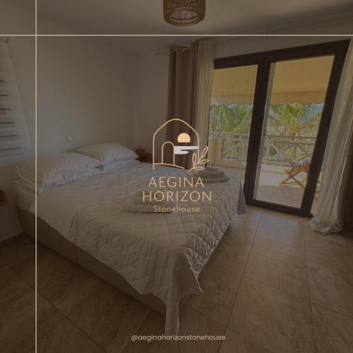 a bedroom with a bed with a view of a patio at Aegina Horizon Stonehouse No I in Aegina