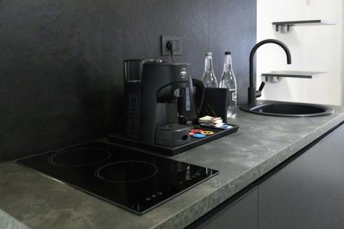 a kitchen counter with a coffee maker and a sink at Suite Piazza Vittorio Emanuele in Mesagne