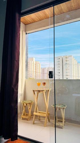a table on a balcony with a view of a city at BOX 360 - Container SUSPENSO! in Uberlândia