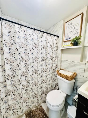 a bathroom with a toilet and a shower curtain at 41 Montrose Master Bedroom in Newark