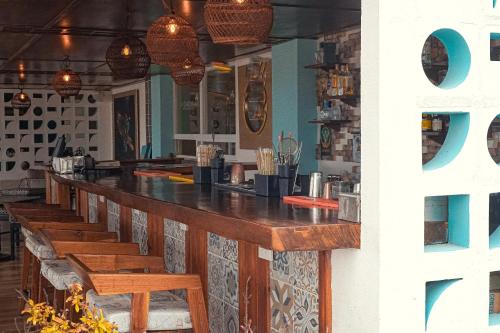 a bar in a restaurant with wooden tables and benches at The Mint Resort Isla Mujeres in Isla Mujeres