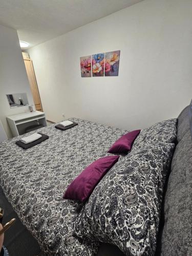 a bedroom with a bed with two pillows on it at Tiny House Ciciban - self check in and check out in Otočac