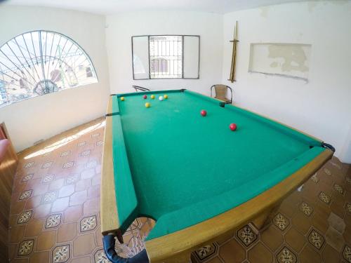a pool table with balls on it in a room at Pousada Cabo Frio in Cabo Frio
