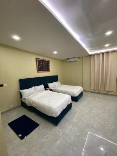 a bedroom with two beds in a room at Villa Angelia Hotel in Accra