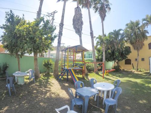 a park with a playground and tables and chairs at Pousada Cabo Frio in Cabo Frio