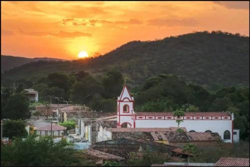 a sunset over a small town with a church at Casa Menezes - Ilha do Ferro - Alagoas in Pão de Açúcar