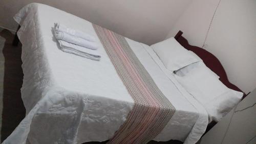 a bedroom with a bed with a white comforter at Casa Menezes - Ilha do Ferro - Alagoas in Pão de Açúcar