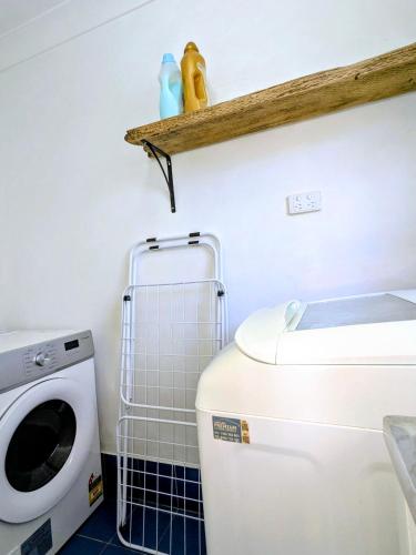 a laundry room with a washer and dryer at Blue Mountains Urban Farm Stay near Sydney in Hazelbrook